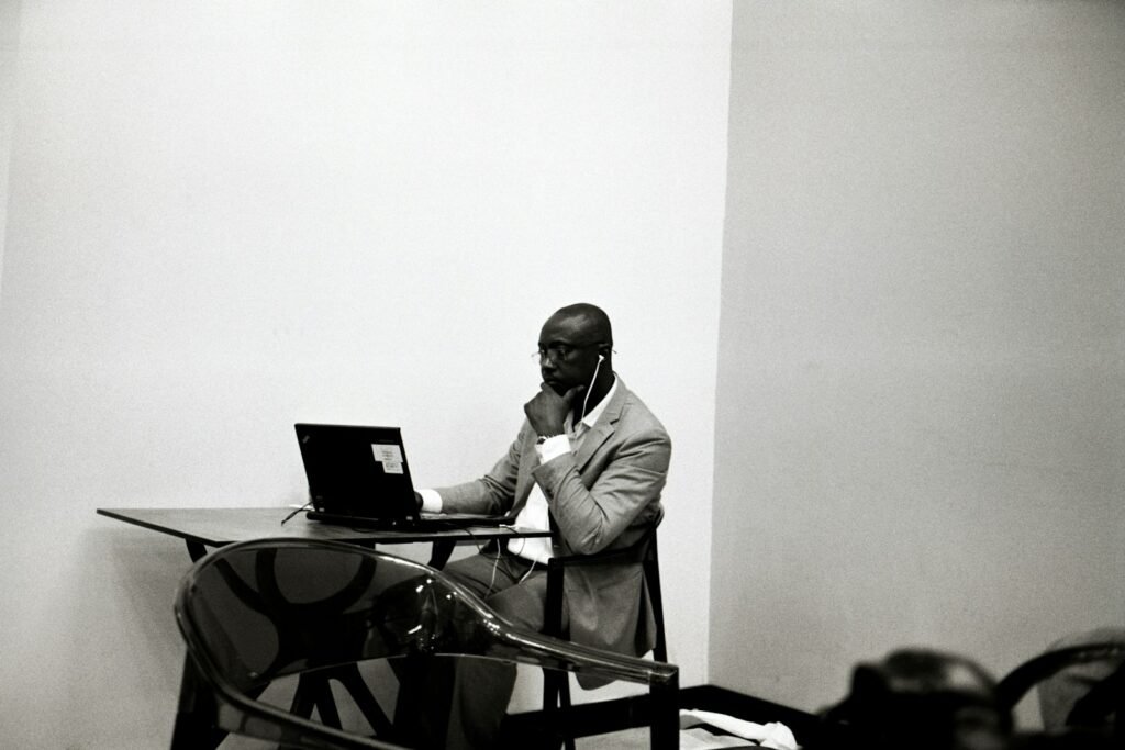 a man sitting at a table using a laptop computer
