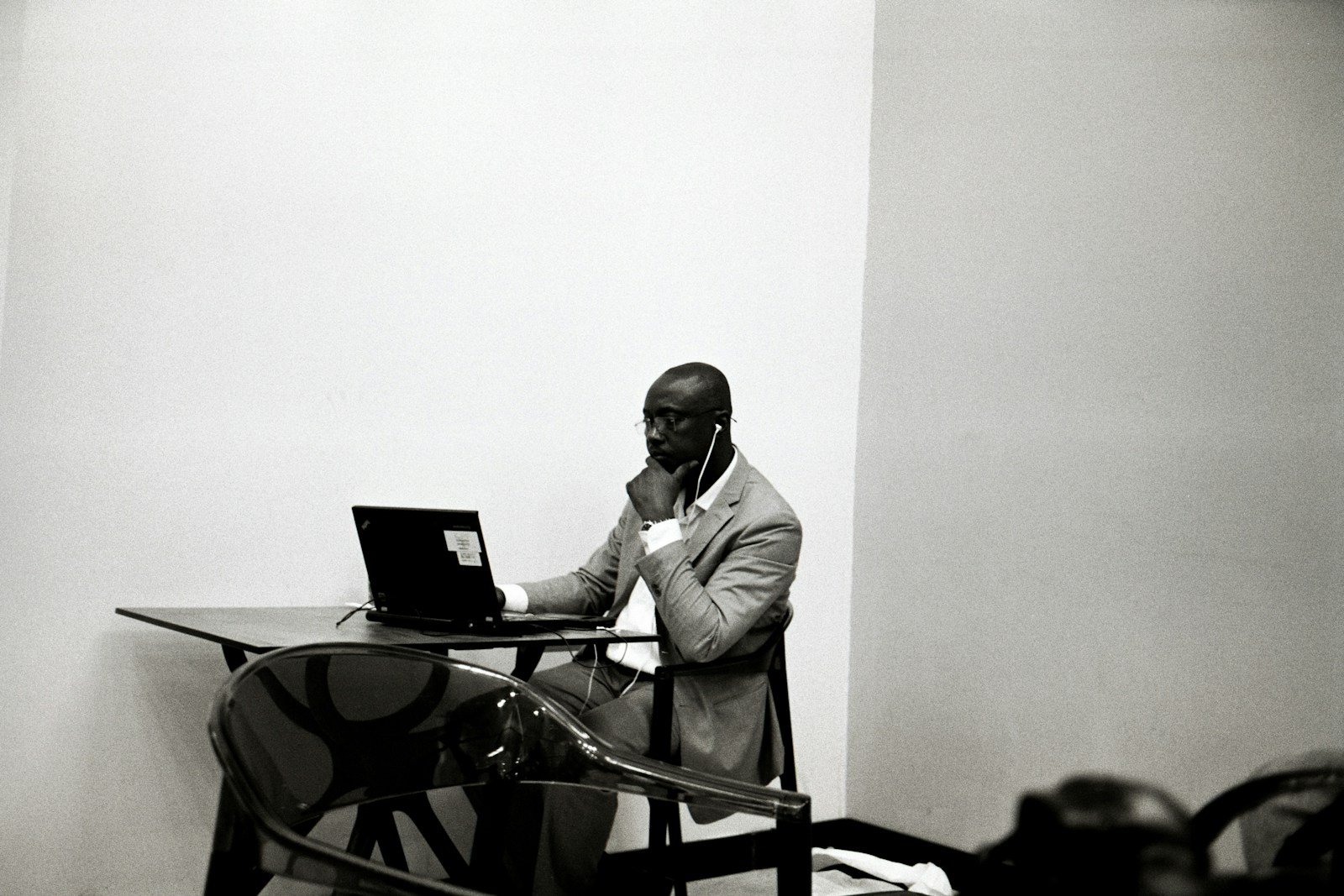 a man sitting at a table using a laptop computer